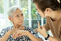 Confused senior lady looking at carer