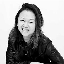 Young lady smiling and looking at camera in black and white