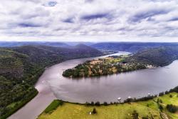 Macdonalds river merges into Hawkesbury river near Wisemans ferry regional town in Blue Mountains national park of Australia - elevated aerial view with perspective