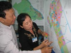 Woman and man using highlighters on a map