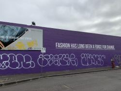 Wall with graffiti and quote "Fashion has long been a force for change"