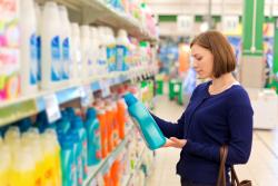 Woman in a shop looking at washing liquids