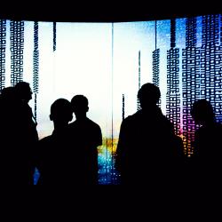 Silhouetted people inside the UTS Data Arena