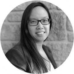 Round black and white photos of a woman against a brick wall looking and smiling at the camera