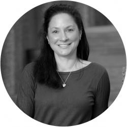 Woman smiling and looking at the camera in black and white