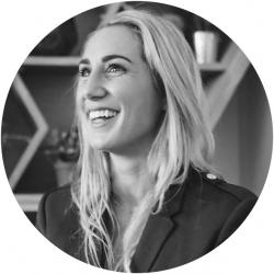 Black and white round photo of a young woman looking off camera smiling