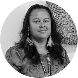 Round black and white photo of a woman smiling and looking at the camera