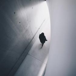 Person walking through concrete building