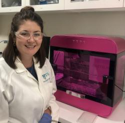 Photo of Claire Richards and RASTRUM bioprinter