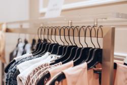 A close-up photo of a rack of clothes on hangers