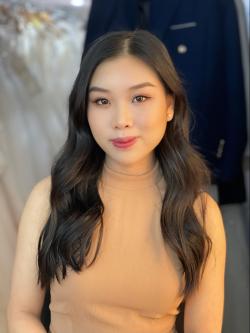 Image of girl with long dark hair smiling at the camera