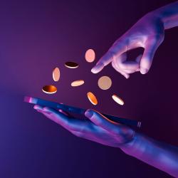 Coins floating above a phone screen, that hands are gingerly reaching to touch