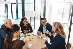 A group of people sitting at a table talking