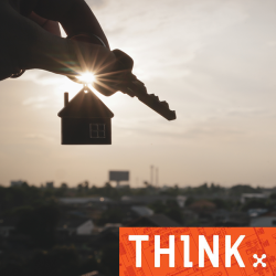 A hand holding a house key