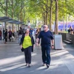 People walking in leafy city scene