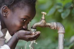 Girl drinking from tap