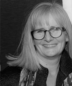 Black and white headshot of WHO director Michelle Rumsey
