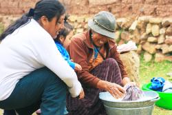 2 females washing clothes