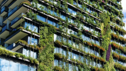Apartment building with plants growing on the exterior walls.