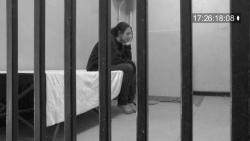 Sorry for your loss woman sitting in a prison cell
