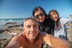 Happy family of three at the beach