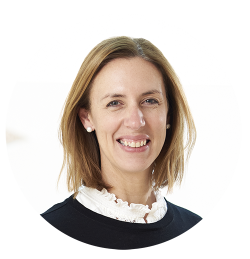 Celia Marston is smiling. She is wearing a navy jumper over a white collared shirt.