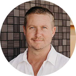 Man smiling and looking at the camera in a white business shirt
