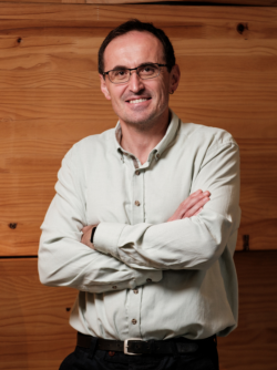 Portrait shot of Isa Hafalir smiling to camera