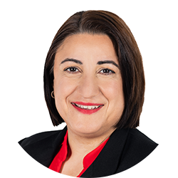 Woman with shoulder length brown hair wearing a red shirt with a black suit jacket