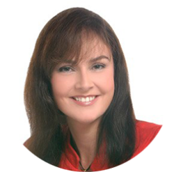Woman with shoulder length brown hair smiling and looking at the camera