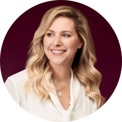 Woman with shoulder length blonde hair looking off camera and smiling