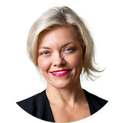 Woman with short blonde hair smiling and looking at the camera
