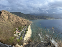 Aerial shot of sea meeting mountains.