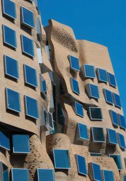 Facade of bricks & protruding, relective windows - Dr Chau Chak Wing building