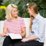 2 people having a discussion sitting down