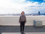 A woman stands in front of the Sydney harbourside skyline