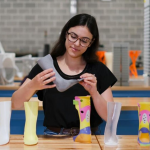 Mechanical and mechatronic engineering student Kate Leone holding a 3D printed ankle-foot orthosis.