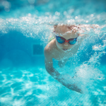 Kid swimming in the pool