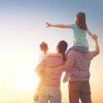 Family of four looking at sunset