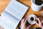 an open book and a cup of coffee