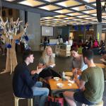 SDG students sitting at tables eating food