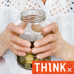 Hands holding a money jar.