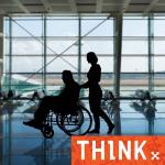 Person pushing a wheel chair at an airport