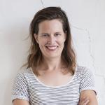 A chest up photo of Anna Clarke smiling at the camera