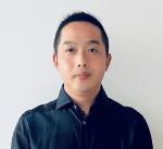 chest up photo of Bing Jie looking at the camera