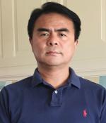 Chest up photo of Sherub Phuntsho looking at the camera