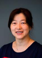 Shoulder up photo of Wenshan Guo smiling at the camera