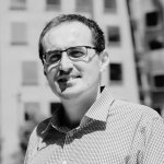 Isa Hafalir smiling with glasses on