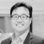 Kyuseop Kwak smiling and has glasses on