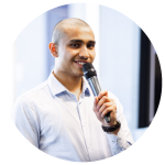 Young male holds microphone and looks into the camera